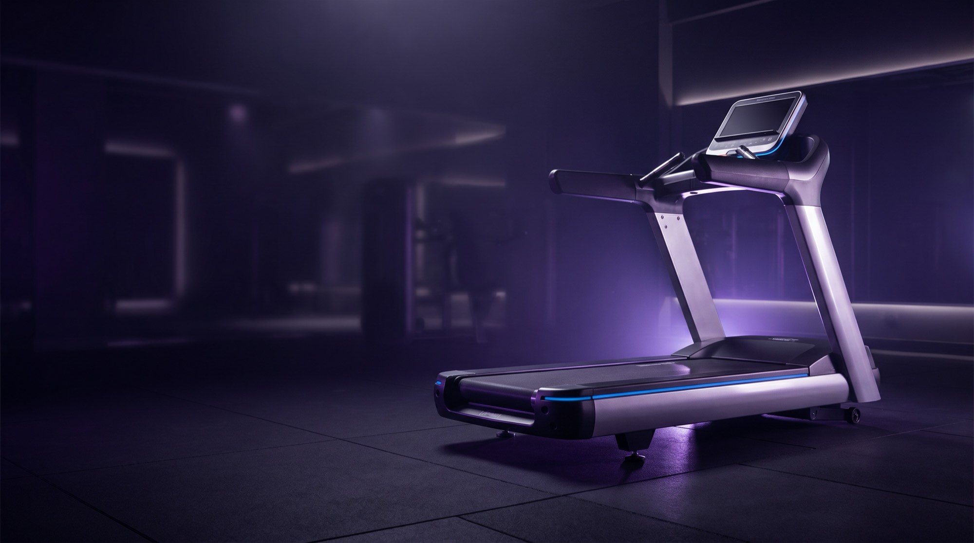 Commercial treadmill in a dark gym